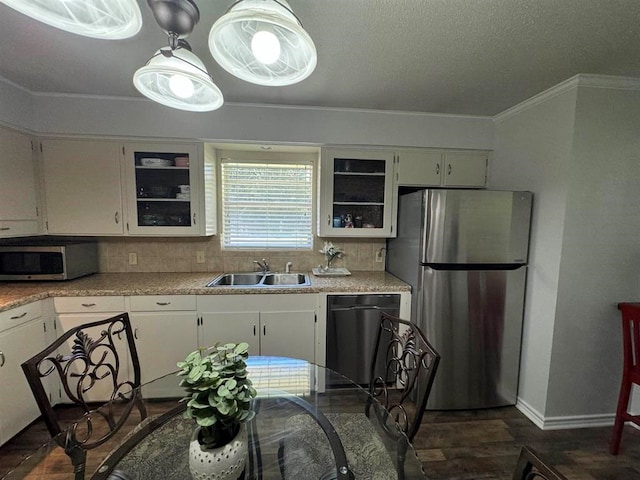 kitchen with white cabinets, decorative backsplash, sink, and appliances with stainless steel finishes