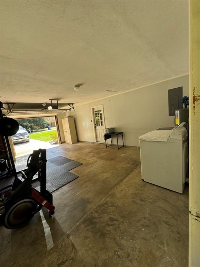 garage featuring independent washer and dryer and electric panel