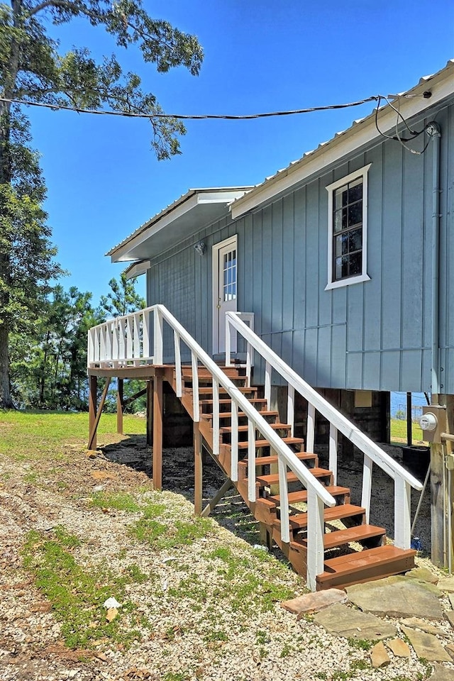 view of home's exterior with stairs and a deck