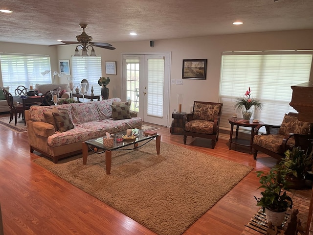 living room featuring a textured ceiling, hardwood / wood-style flooring, and plenty of natural light