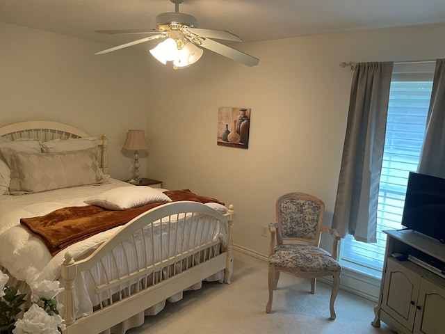 bedroom with light carpet and ceiling fan