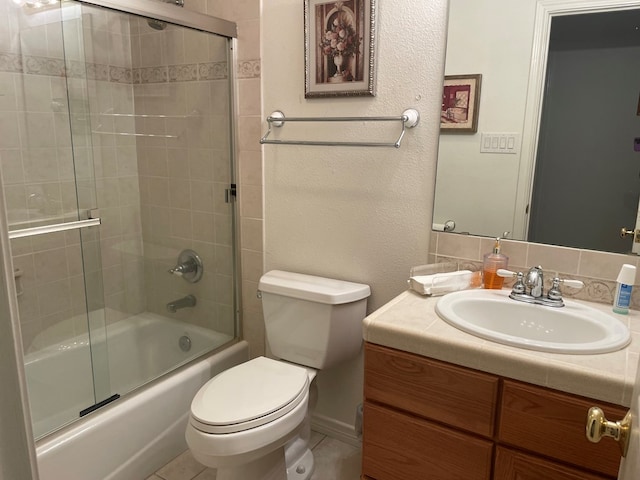 full bathroom featuring vanity, bath / shower combo with glass door, and toilet