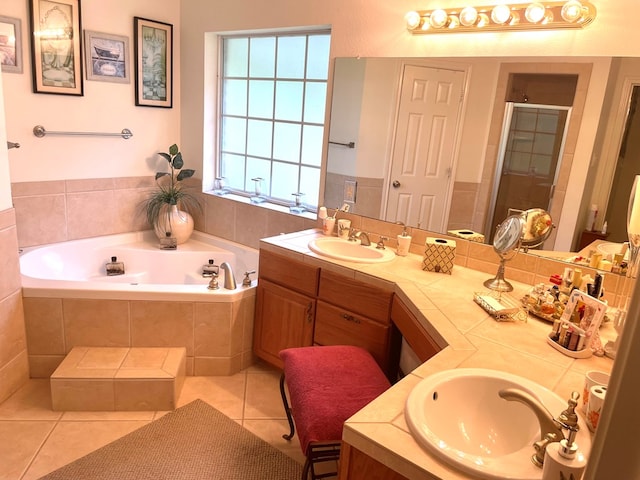 bathroom featuring shower with separate bathtub, vanity, and tile patterned floors