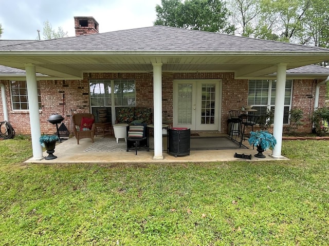 rear view of house featuring a patio and a lawn