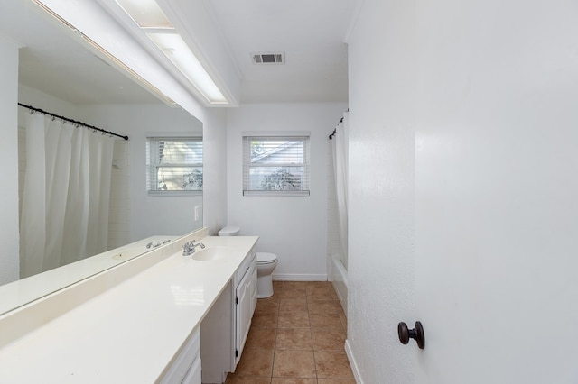 bathroom with tile patterned flooring, toilet, vanity, visible vents, and baseboards