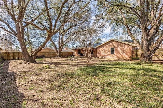 view of yard with a fenced backyard