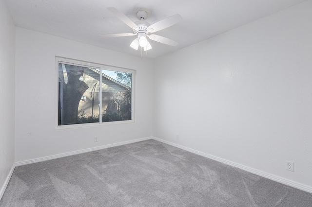 spare room with ceiling fan, baseboards, and carpet flooring