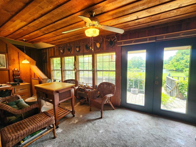 living room featuring ceiling fan, a fireplace, and vaulted ceiling