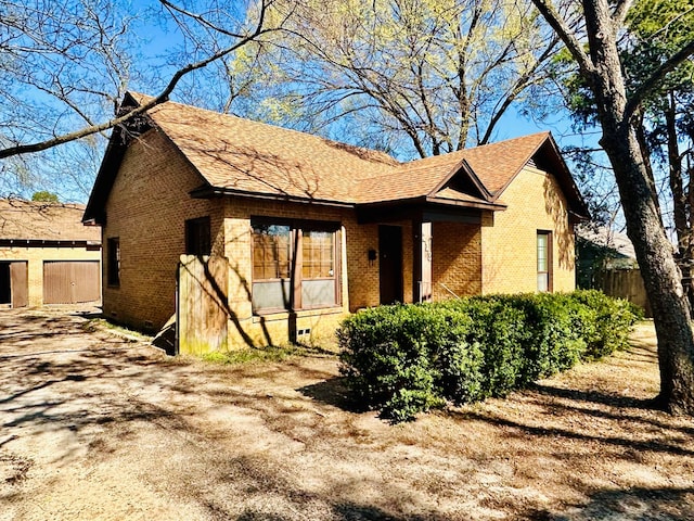 view of front of property featuring fence and brick siding