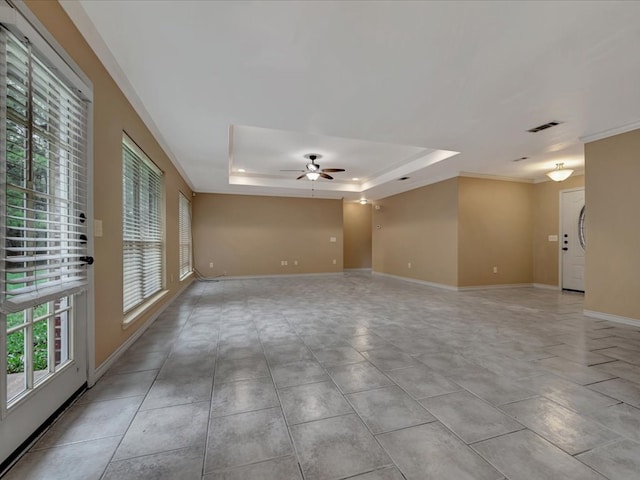 spare room featuring ceiling fan, ornamental molding, and a tray ceiling