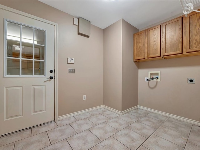 laundry area with hookup for an electric dryer, light tile patterned flooring, cabinets, and hookup for a washing machine