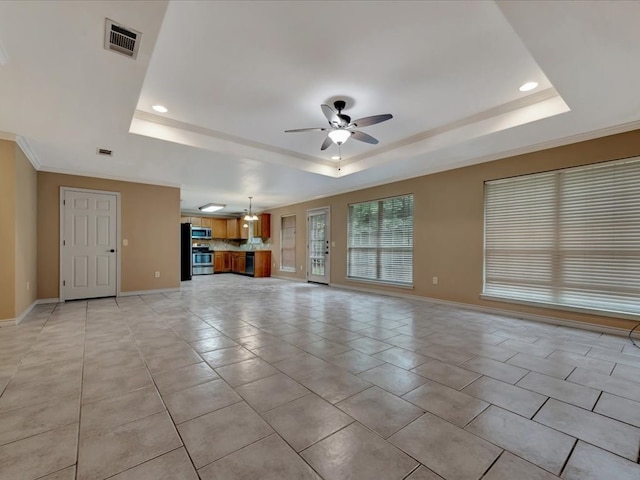 unfurnished living room featuring a raised ceiling, ceiling fan, light tile patterned flooring, and ornamental molding