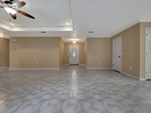 entrance foyer with a tray ceiling, ceiling fan, and crown molding