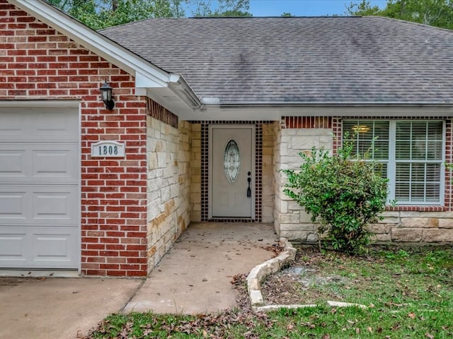 view of exterior entry with a garage