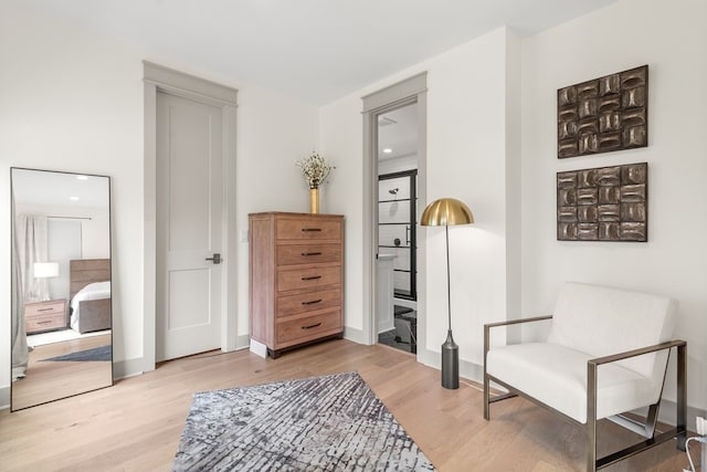 sitting room with recessed lighting, baseboards, and light wood finished floors