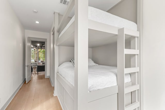 bedroom featuring visible vents, recessed lighting, light wood-style floors, and baseboards