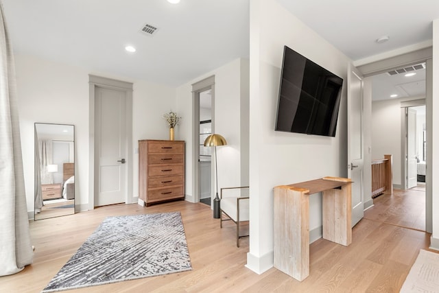corridor featuring visible vents, recessed lighting, light wood finished floors, and baseboards