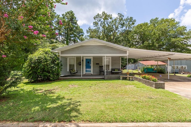 view of front of house with a carport, covered porch, and a front lawn