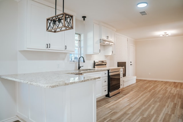 kitchen with sink, light stone counters, decorative light fixtures, white cabinets, and stainless steel range with electric cooktop