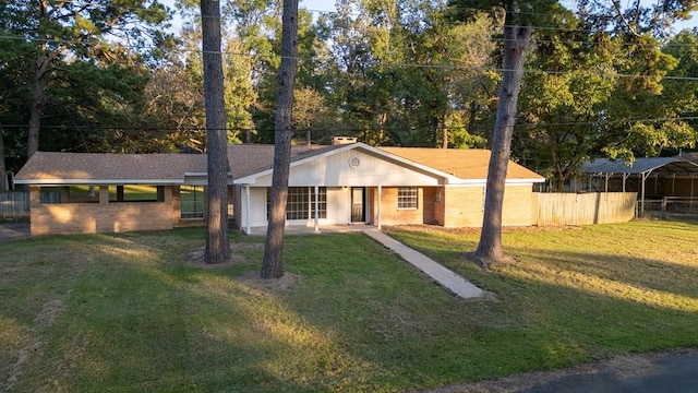 ranch-style home featuring a front yard