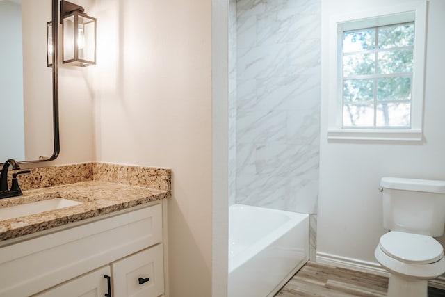 bathroom with hardwood / wood-style flooring, vanity, and toilet