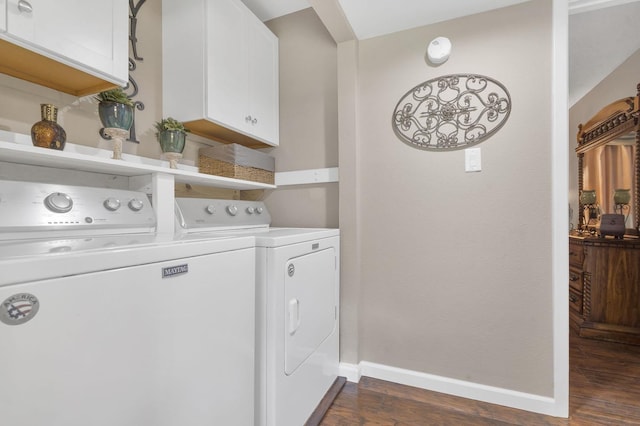 laundry room featuring cabinets, washer and clothes dryer, and dark wood-type flooring