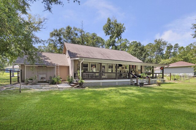 rear view of property with a lawn