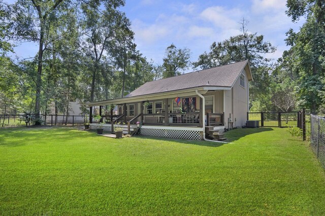 back of house featuring cooling unit, a deck, and a yard