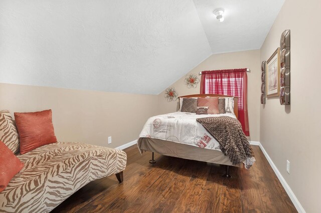 bedroom with hardwood / wood-style flooring and lofted ceiling