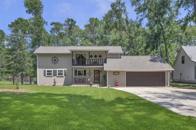 view of front facade with a porch, a balcony, a front yard, and a garage