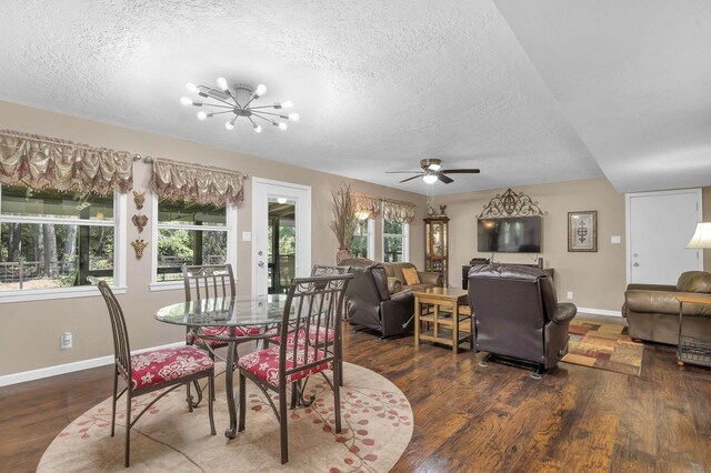 dining space featuring a textured ceiling, dark hardwood / wood-style floors, and a wealth of natural light