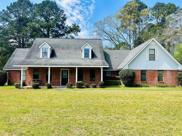 4928 Fm 252, Jasper, TX 75951 - new england style home featuring a front yard, a porch, and brick siding