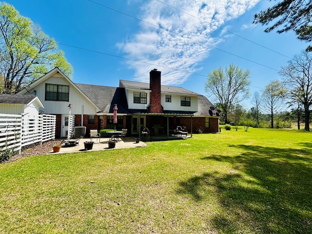 4928 Fm 252, Jasper, TX 75951 - rear view of property with cooling unit, a chimney, a yard, brick siding, and a patio area