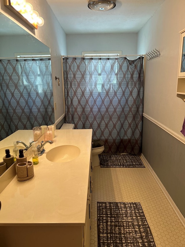 4928 Fm 252, Jasper, TX 75951 - full bathroom with vanity, toilet, baseboards, tile patterned floors, and a shower with curtain