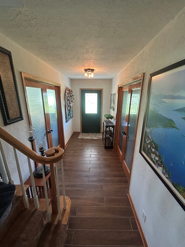 4928 Fm 252, Jasper, TX 75951 - entryway with french doors, a textured wall, a textured ceiling, dark wood-style floors, and stairway