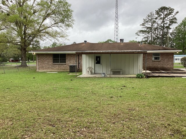 500 Herndon St, Kirbyville, TX 75956 - rear view of house with fence, a wooden deck, brick siding, central AC, and a lawn