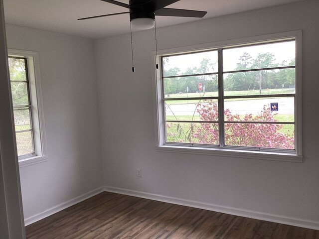 500 Herndon St, Kirbyville, TX 75956 - spare room featuring dark wood-type flooring, ceiling fan, and plenty of natural light