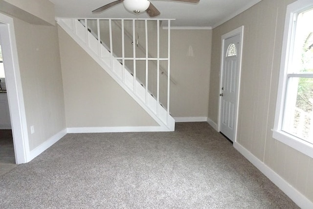 foyer with carpet, baseboards, and stairs