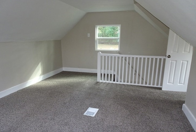 bonus room with vaulted ceiling, carpet, and baseboards