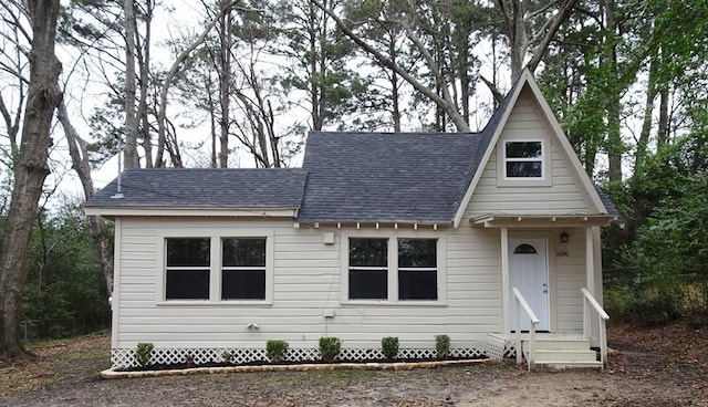 view of front facade featuring a shingled roof and entry steps