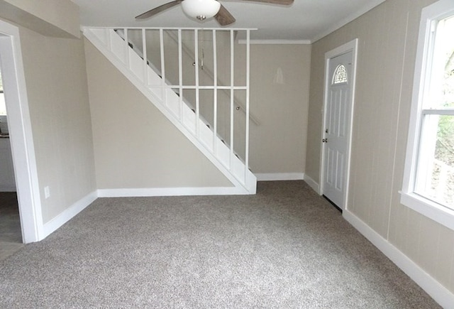 entrance foyer featuring stairs, carpet flooring, and baseboards