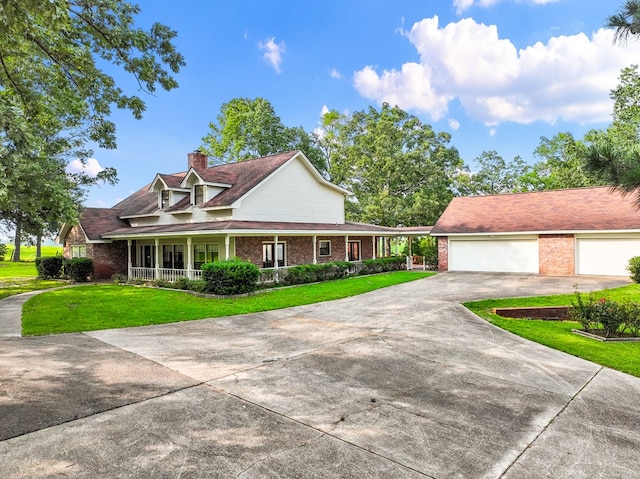 view of front of property with a front lawn, covered porch, and a garage