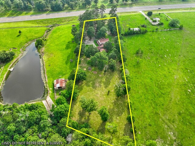 birds eye view of property featuring a rural view and a water view