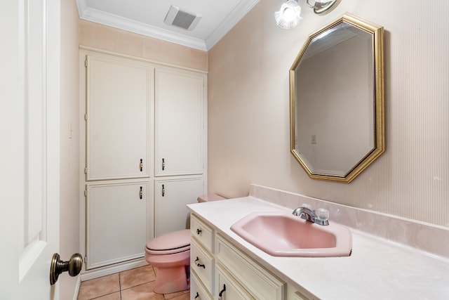 bathroom featuring tile patterned flooring, vanity, toilet, and crown molding