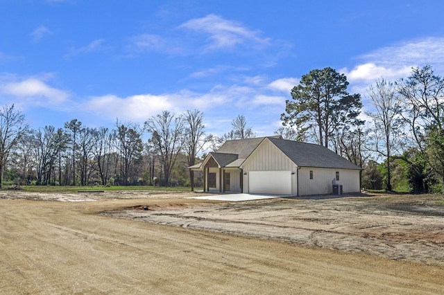 view of side of home with driveway and a garage