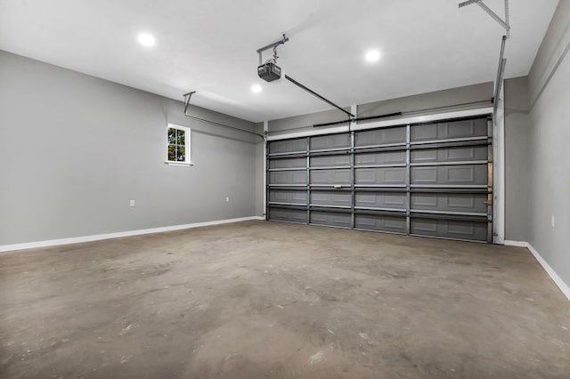 garage with a garage door opener and baseboards