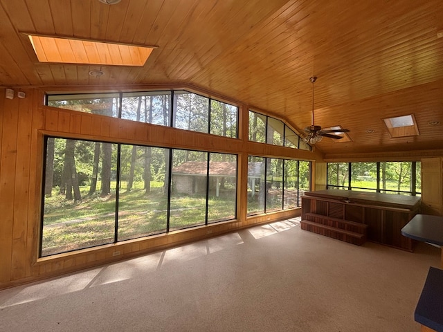 707 Pine St, Center, TX 75935 - unfurnished sunroom featuring a skylight, wooden ceiling, carpet flooring, wooden walls, and high vaulted ceiling