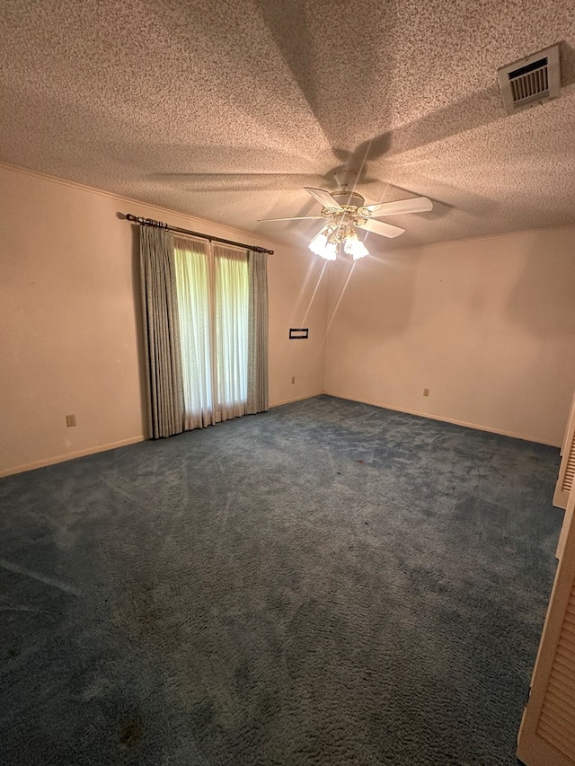 707 Pine St, Center, TX 75935 - unfurnished room with ceiling fan, dark carpet, and a textured ceiling