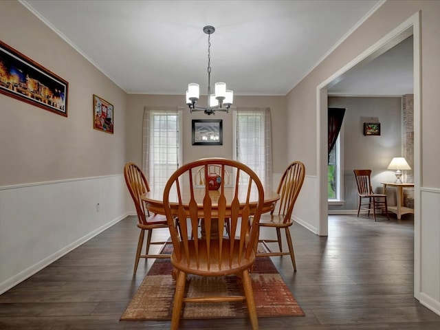 2600 Dogwood St, Nacogdoches, TX 75965 - dining area featuring a chandelier, dark wood-type flooring, crown molding, and a wainscoted wall
