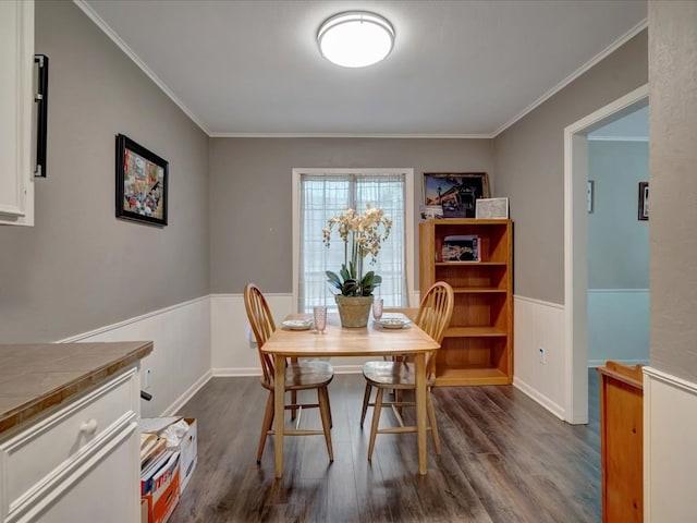 2600 Dogwood St, Nacogdoches, TX 75965 - dining area featuring wainscoting, dark wood-type flooring, and ornamental molding